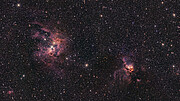 The image shows two cosmic clouds of purple with a golden orange glow towards their centres. The clouds are found separated from each other on each side of the image. The clouds stand out against a black background with a myriad of stars.