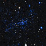 Composite of X-ray and visible light views of a distant cluster of galaxies