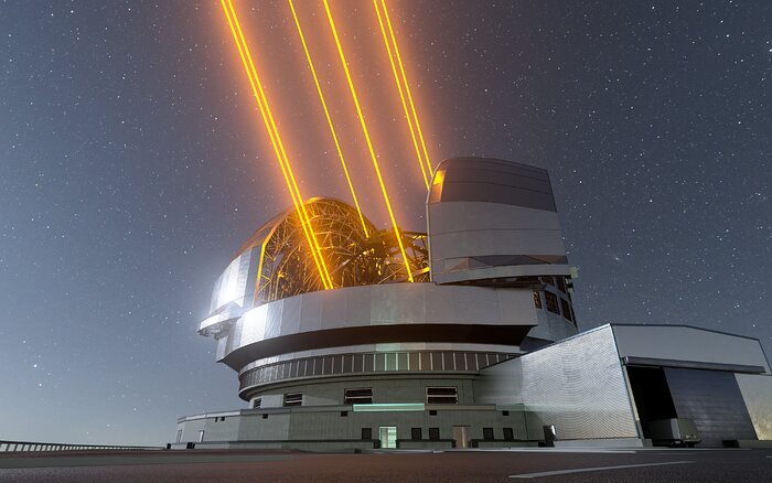 The silvery, rounded dome of the Extremely Large Telescope sits in the centre of this image, against a backdrop of stars. To the right of the dome is a smaller, more squat building attached to the main facility. The centre of the ELT's dome is open, with its doors moving to the side to reveal the core of the telescope, which is shooting out 6 bright-orange lasers towards the top-left of the image, 3 beams on each side of the telescope.