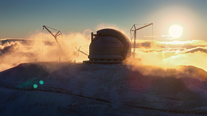 A giant spherical dome on the flat top of a mountain. Low clouds drift around the dome and nearby cranes as the low Sun in the background bathes the scene in warm light.